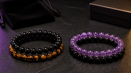 Black obsidian tiger eye and amethyst bracelet sets on a dark surface