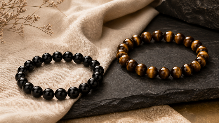 Black obsidian bracelet and golden tiger eye bracelet styled together for comparison