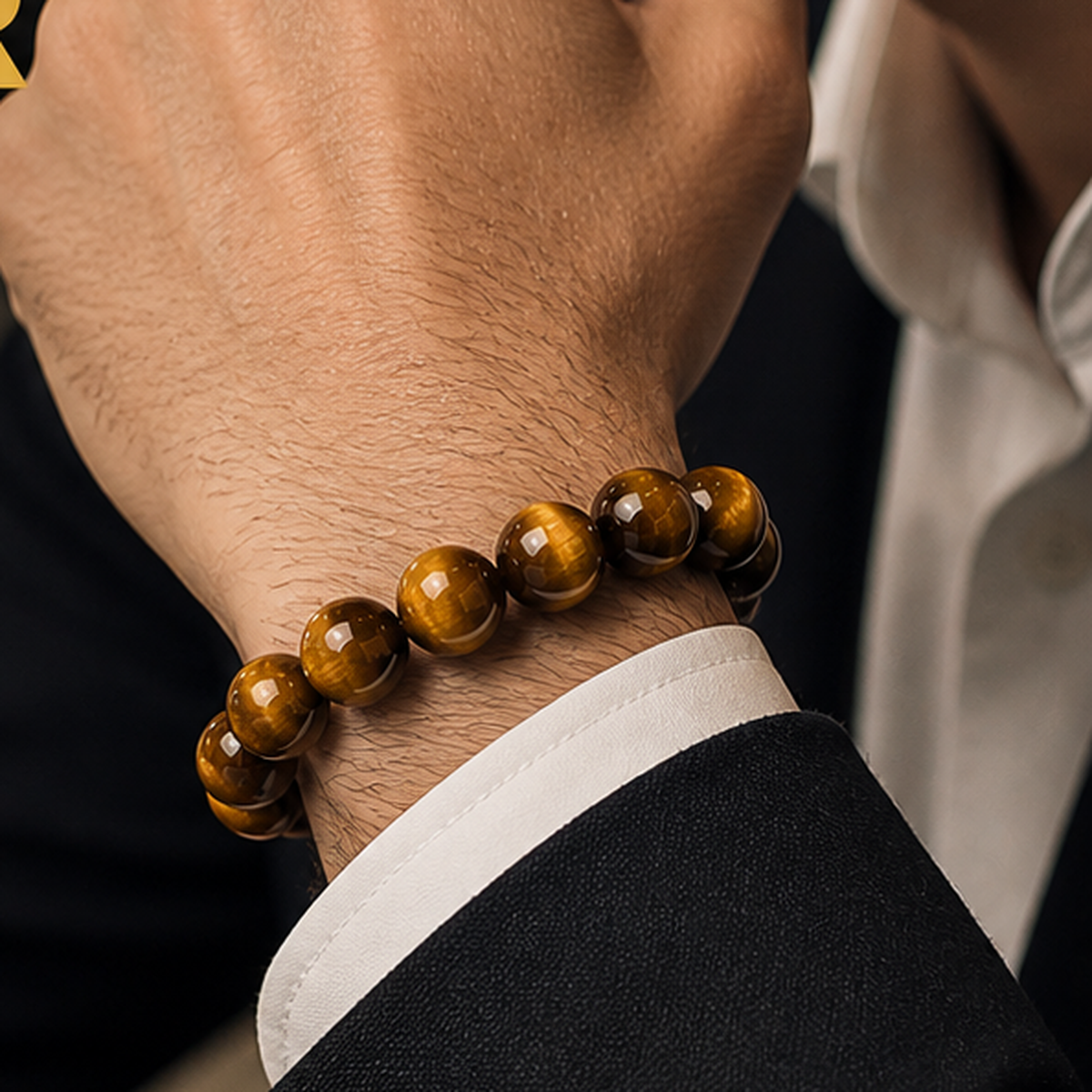 Golden Tiger Eye bracelet worn on the wrist with a dark sleeve