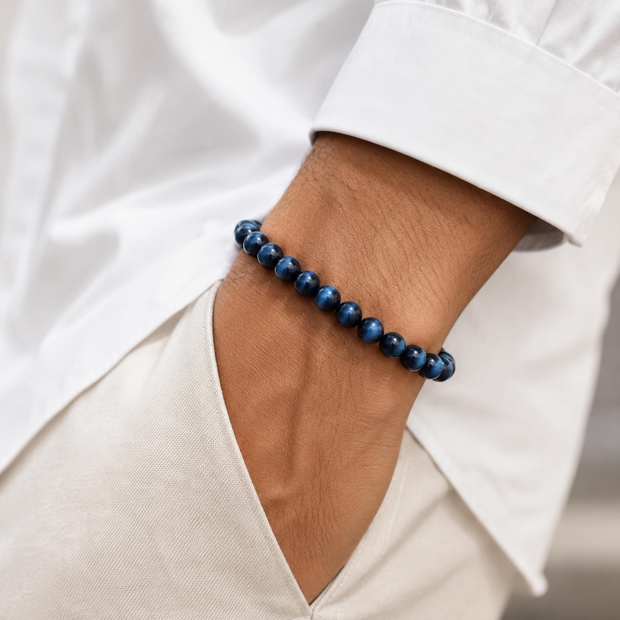 Blue Tiger Eye bracelet styled with a black watch and sunglasses